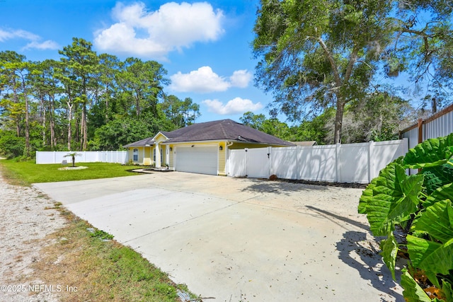 12139 Cap Ferrat St, Jacksonville, FL 32224 - view of side of property with a yard, fence, a garage, and concrete driveway