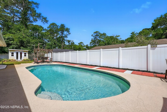 12139 Cap Ferrat St, Jacksonville, FL 32224 - view of pool featuring an outbuilding, a fenced in pool, a storage structure, a patio area, and a fenced backyard