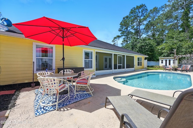 12139 Cap Ferrat St, Jacksonville, FL 32224 - view of swimming pool featuring outdoor dining area, a fenced in pool, an outdoor structure, a patio area, and a sunroom