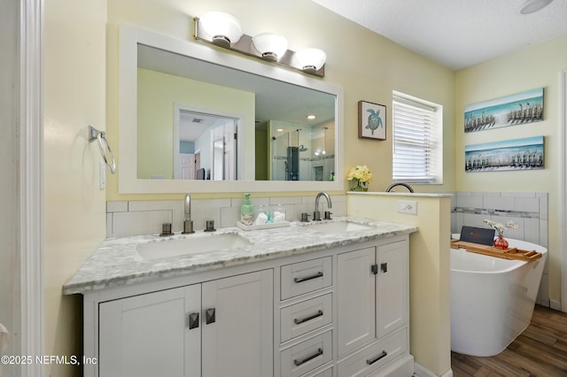 12139 Cap Ferrat St, Jacksonville, FL 32224 - full bath featuring a shower stall, double vanity, a sink, and wood finished floors