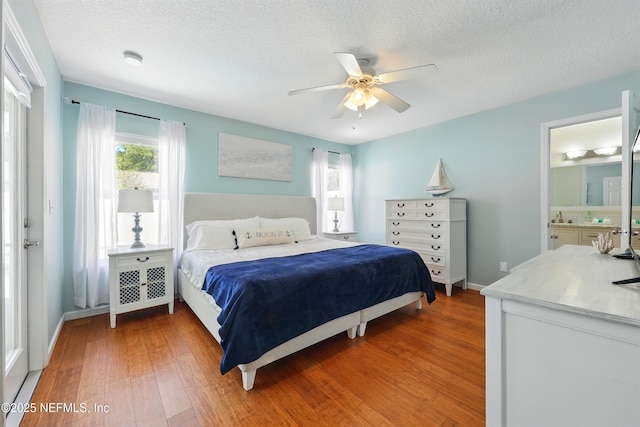 12139 Cap Ferrat St, Jacksonville, FL 32224 - bedroom with ensuite bathroom, a textured ceiling, ceiling fan, light wood-style flooring, and baseboards