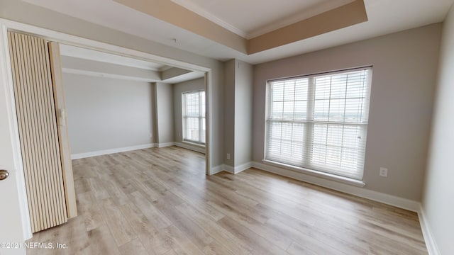 400 E Bay St Unit 1610-1611, Jacksonville, FL 32202 - spare room with light wood-style floors, ornamental molding, a raised ceiling, and baseboards