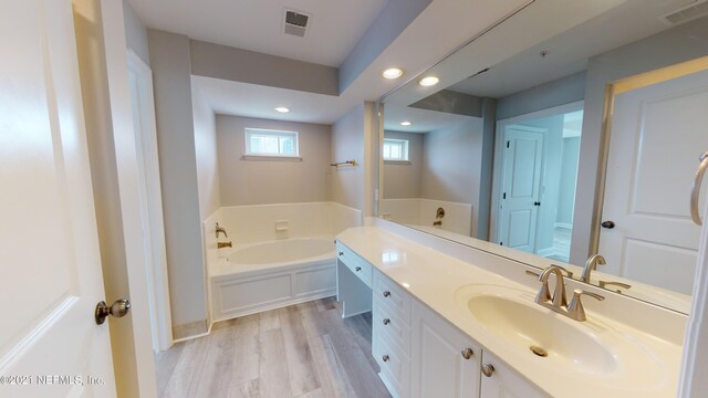 400 E Bay St Unit 1610-1611, Jacksonville, FL 32202 - full bath with recessed lighting, visible vents, a garden tub, and vanity