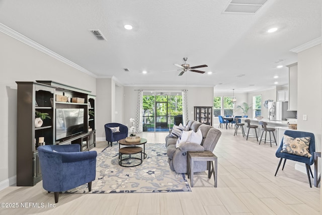 living room featuring crown molding, recessed lighting, and visible vents