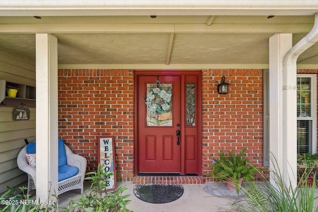 5914 Orchard Pond Dr, Fleming Island, FL 32003 - view of exterior entry featuring brick siding and covered porch