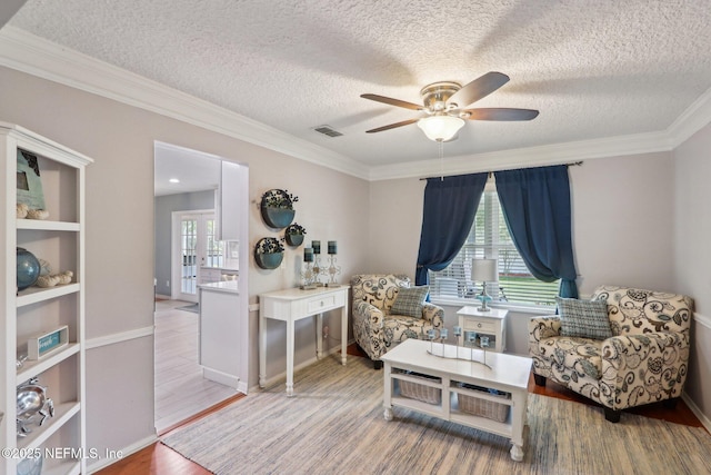 5914 Orchard Pond Dr, Fleming Island, FL 32003 - living area with a ceiling fan, wood finished floors, crown molding, a textured ceiling, and baseboards