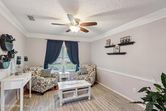 5914 Orchard Pond Dr, Fleming Island, FL 32003 - living area featuring a ceiling fan, ornamental molding, a textured ceiling, and wood finished floors