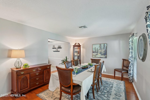 5914 Orchard Pond Dr, Fleming Island, FL 32003 - dining area featuring wood finished floors, a textured ceiling, and baseboards