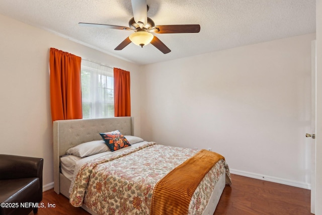 5914 Orchard Pond Dr, Fleming Island, FL 32003 - bedroom featuring wood finished floors, a textured ceiling, baseboards, and a ceiling fan