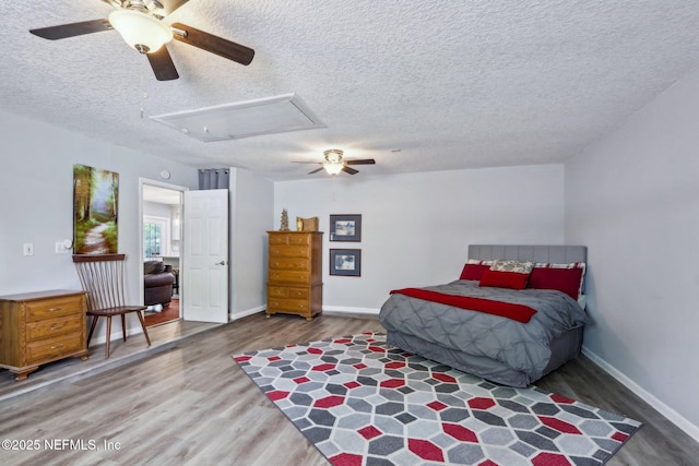 5914 Orchard Pond Dr, Fleming Island, FL 32003 - bedroom with attic access, wood finished floors, a textured ceiling, baseboards, and a ceiling fan