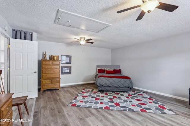 5914 Orchard Pond Dr, Fleming Island, FL 32003 - bedroom with attic access, wood finished floors, baseboards, a textured ceiling, and a ceiling fan