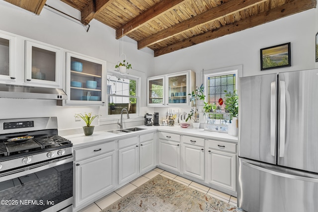 120 Washington St, Saint Augustine, FL 32084 - kitchen with appliances with stainless steel finishes, a sink, wooden ceiling, light tile patterned floors, and under cabinet range hood