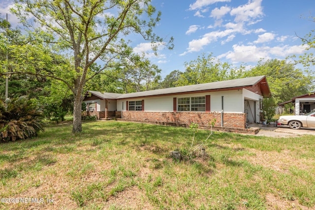 single story home with brick siding, a front yard, and a garage
