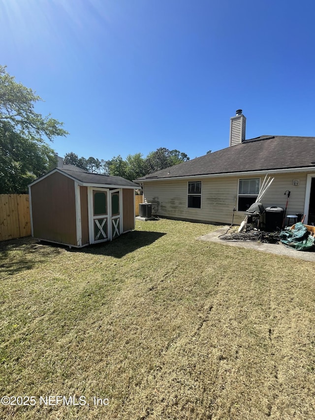 2990 Brittany Bluff Dr, Orange Park, FL 32073 - view of yard featuring a storage shed, fence, an outbuilding, and central air condition unit