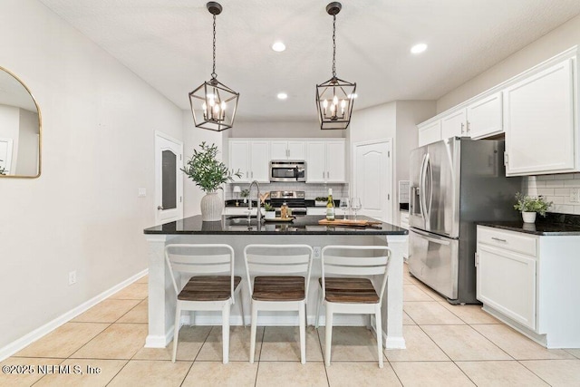 3149 Silverado Cir, Green Cove Springs, FL 32043 - kitchen featuring stainless steel appliances, a chandelier, backsplash, dark countertops, and white cabinets