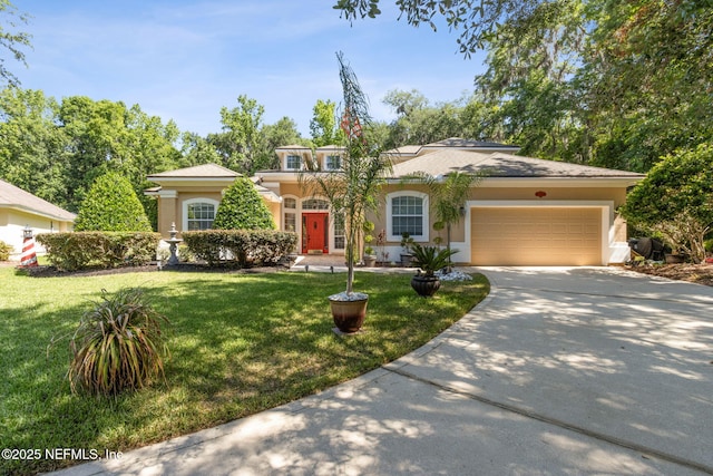 view of front of property with a garage, stucco siding, concrete driveway, and a front lawn