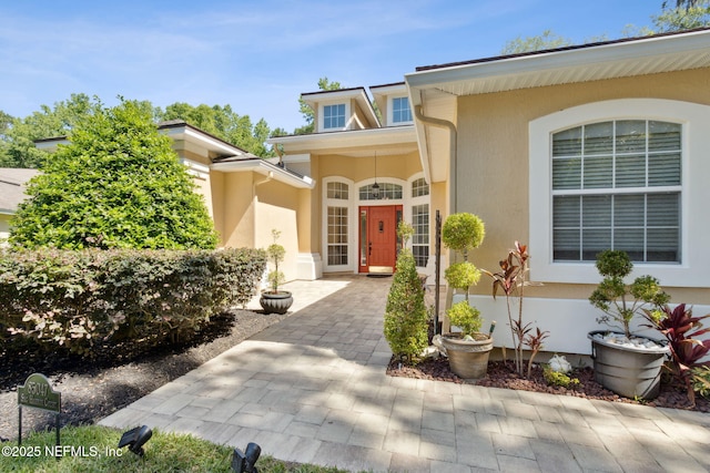 property entrance featuring stucco siding