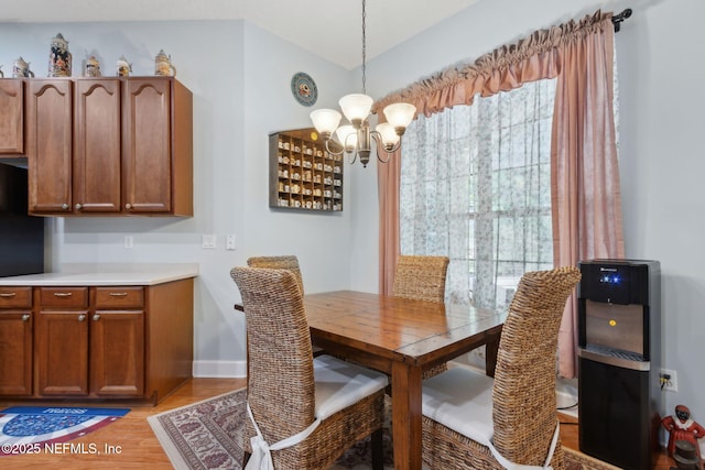 dining space featuring an inviting chandelier and light wood-style floors