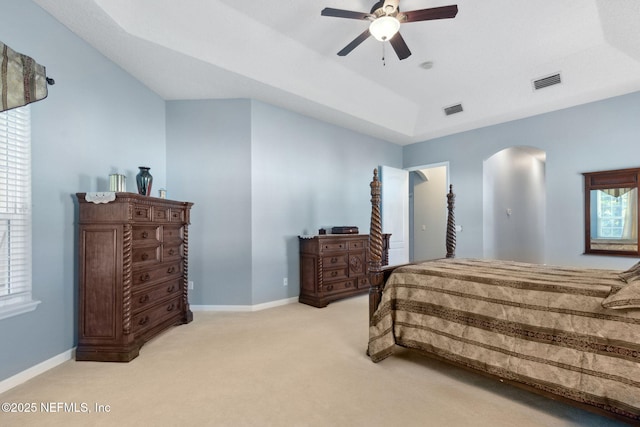 bedroom featuring visible vents, carpet flooring, baseboards, and arched walkways