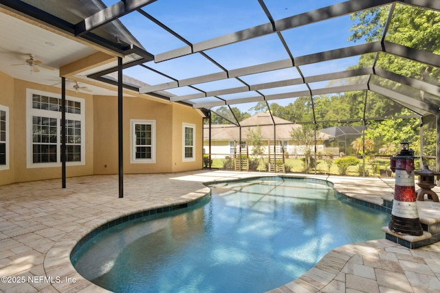 outdoor pool with a patio, ceiling fan, and a lanai