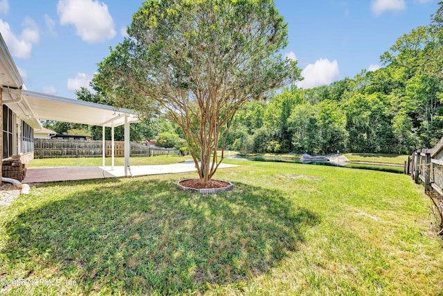 view of yard with fence and a patio area