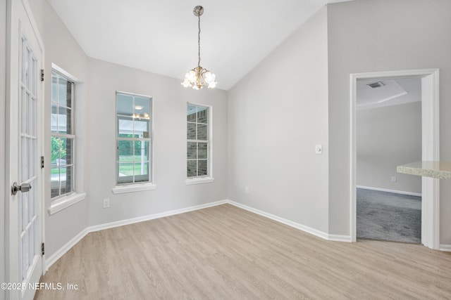 unfurnished room with baseboards, a notable chandelier, visible vents, and light wood-style floors