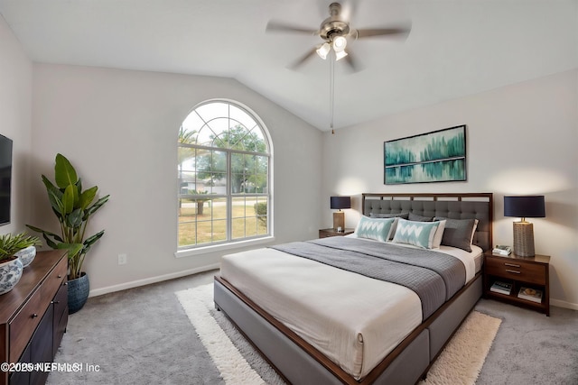 carpeted bedroom featuring a ceiling fan, baseboards, and vaulted ceiling
