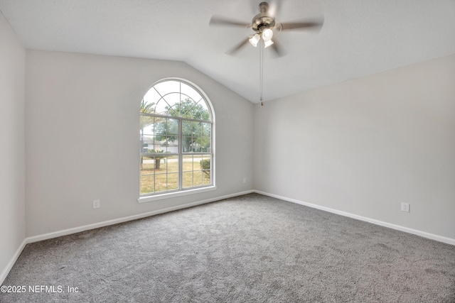carpeted empty room with baseboards, ceiling fan, and lofted ceiling