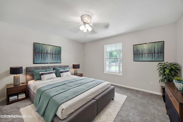carpeted bedroom with baseboards and ceiling fan