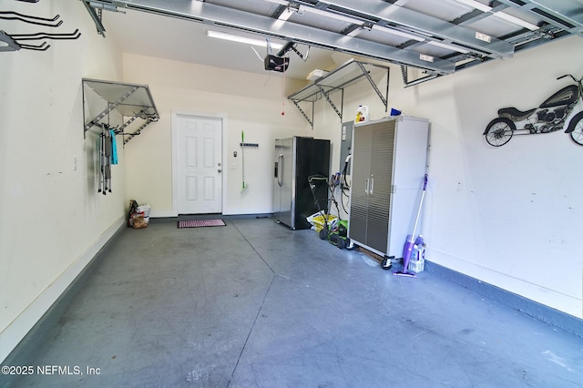 garage featuring stainless steel fridge, baseboards, and a garage door opener