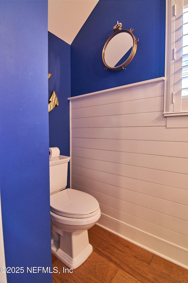 half bath featuring toilet and wood finished floors