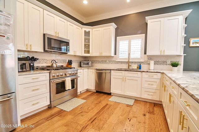 kitchen featuring a sink, stainless steel appliances, and white cabinetry