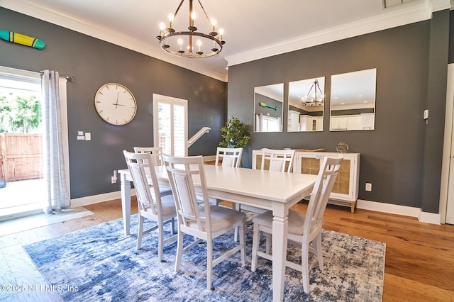 dining area with crown molding, a notable chandelier, and plenty of natural light
