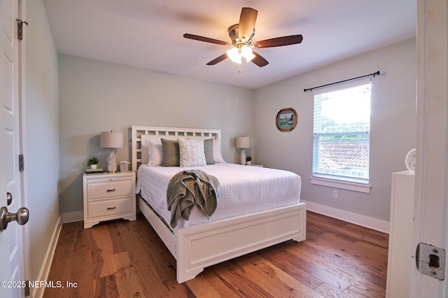 bedroom featuring ceiling fan, baseboards, and wood finished floors
