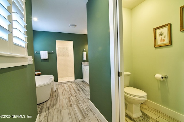 full bath featuring toilet, baseboards, a walk in shower, vanity, and wood finish floors