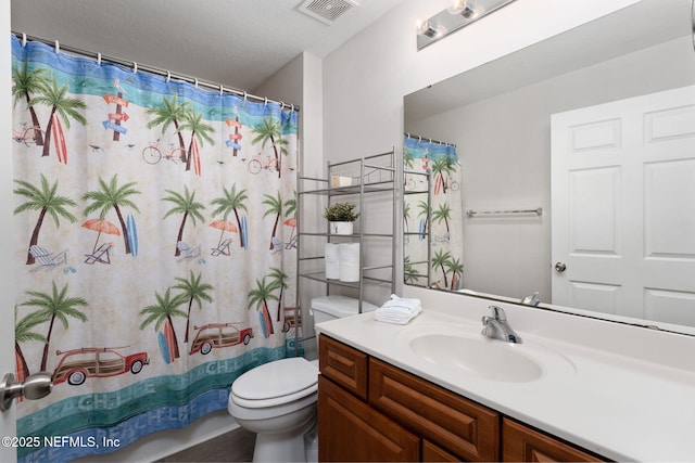 bathroom featuring toilet, visible vents, shower / tub combo, and vanity