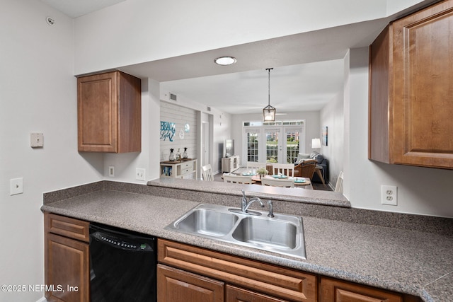 kitchen featuring a sink, black dishwasher, and brown cabinets