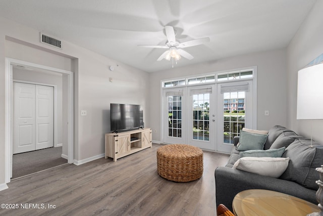 living room with french doors, a ceiling fan, visible vents, wood finished floors, and baseboards