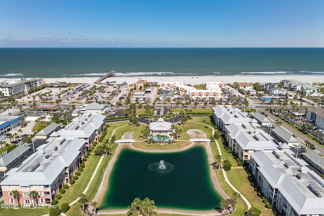 birds eye view of property with a water view and a view of the beach