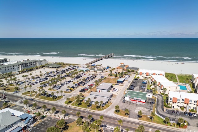 aerial view with a water view and a beach view