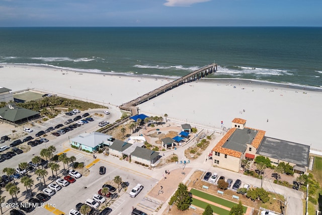 birds eye view of property with a beach view and a water view