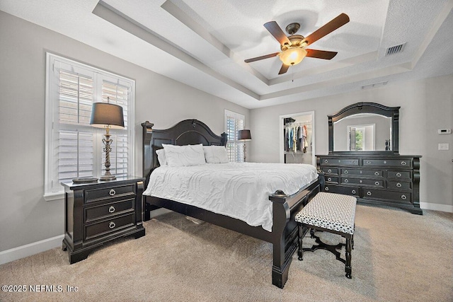 135 Outpost Trl, Ponte Vedra, FL 32081 - carpeted bedroom featuring a raised ceiling, baseboards, a walk in closet, a ceiling fan, and a closet