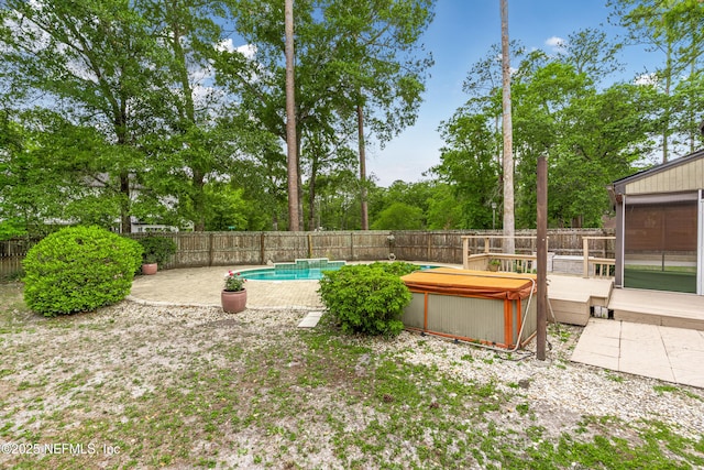 view of yard with a fenced backyard, a fenced in pool, a patio area, and a wooden deck
