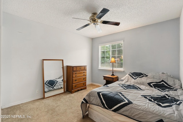 bedroom with baseboards, carpet, a ceiling fan, and a textured ceiling