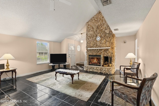living room with a textured ceiling, visible vents, baseboards, and vaulted ceiling