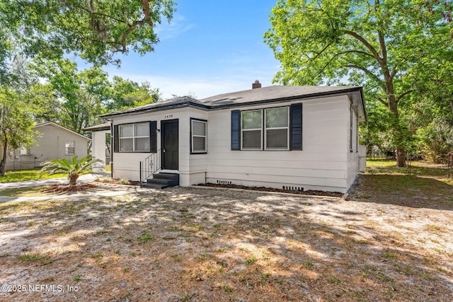 bungalow-style house featuring a chimney, fence, crawl space, and entry steps
