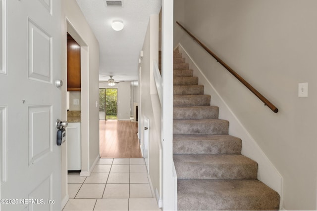 3801 Crown Point Rd Unit 1032, Jacksonville, FL 32257 - stairway featuring baseboards, tile patterned floors, visible vents, and ceiling fan