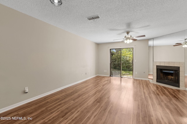 3801 Crown Point Rd Unit 1032, Jacksonville, FL 32257 - unfurnished living room with visible vents, ceiling fan, wood finished floors, and a fireplace