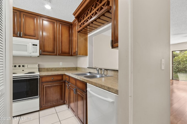 3801 Crown Point Rd Unit 1032, Jacksonville, FL 32257 - kitchen with a sink, a textured ceiling, white appliances, and light countertops