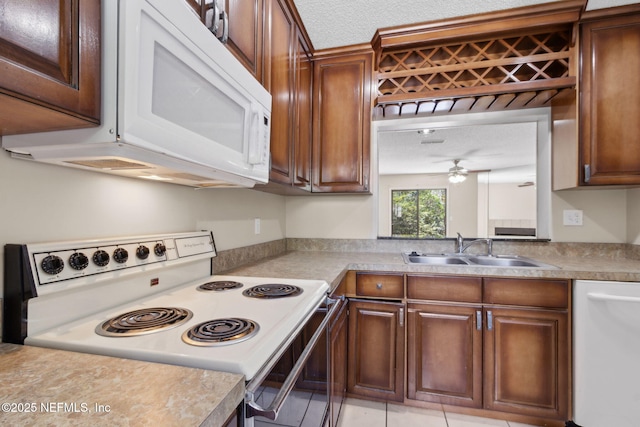 3801 Crown Point Rd Unit 1032, Jacksonville, FL 32257 - kitchen with a ceiling fan, a sink, light countertops, light tile patterned floors, and white appliances